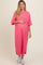 woman wearing a pink and white striped maternity dress and holding her baby bump