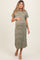 woman wearing a green and white striped maternity maxi dress, showcasing her baby bump