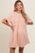 woman wearing a pink maternity dress with short sleeves and a relaxed fit, showcasing a baby bump