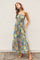 woman wearing a blue floral maxi dress with spaghetti straps and a tie waist detail