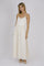 woman wearing a cream spaghetti strap maxi dress with floral embroidery and a ruched bodice