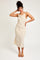 woman wearing a cream sleeveless midi dress with a draped neckline and a relaxed fit
