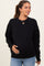 woman wearing a black oversized maternity sweatshirt and holding her baby bump