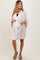 woman wearing a light pink maternity robe with a tie waist and 3/4 sleeves, showcasing her baby bump
