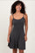 woman wearing a black and white striped sleeveless fit-and-flare dress with a scoop neckline