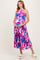 woman wearing a colorful floral maternity maxi dress and holding her baby bump