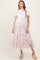 woman wearing a floral print maternity maxi dress with ruffle details and short sleeves, showcasing a baby bump