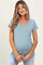 woman wearing a light teal maternity t-shirt with a pocket and a visible baby bump