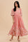 woman wearing a pink floral maxi dress with puff sleeves and a square neckline