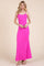 woman wearing a bright pink maxi dress with thin straps and a form-fitting silhouette