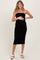 woman wearing a black strapless maternity dress and holding her baby bump
