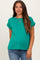 woman wearing a vibrant green short sleeve maternity top and showing her baby bump with casual jeans