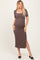 woman wearing a brown ribbed maternity dress with a square neckline and side slit