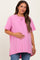 woman wearing a hot pink oversized maternity t-shirt while holding her baby bump