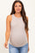 woman wearing a beige maternity tank top with ribbed texture and a form-fitting style, showcasing her baby bump