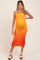 woman wearing a colorful orange maternity dress with ruched details and a visible baby bump