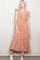 woman wearing a rust and cream gingham midi dress with ruffle sleeves and a tiered skirt