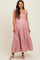 woman wearing a pink and white gingham maternity maxi dress with ruffles and buttons