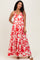 woman wearing a red and white floral maternity maxi dress with a tiered skirt and adjustable straps