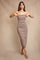 woman wearing a strapless striped midi dress with a fitted silhouette and a neutral color palette