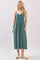 woman wearing a teal maxi dress with a bow tie detail at the bust and spaghetti straps
