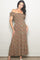 woman wearing a floral print off-the-shoulder maxi dress with ruffled sleeves and a fitted bodice