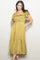 woman wearing a mustard yellow polka dot midi dress with smocked bodice and ruffled sleeves, posing with hands in pockets