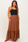 woman wearing a black tank top and a brown maternity maxi skirt with buttons and pockets, displaying a baby bump