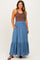 woman wearing a brown tank top and a blue maternity maxi skirt with buttons and pockets