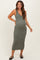 woman wearing a green and white striped maternity dress with a fitted silhouette and a scoop neckline, showcasing her baby bump