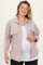 woman wearing a light pink maternity plus shirt jacket over a white top and showing her baby bump