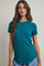 woman wearing a teal short sleeve ribbed top with a curved hem and relaxed fit