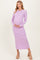 woman wearing a light purple ribbed maternity dress and holding her baby bump