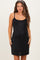 woman wearing a black sparkly maternity dress with adjustable straps and a visible baby bump