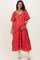 woman wearing a red floral maternity dress with puff sleeves and holding her baby bump