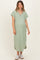 woman wearing a green maternity maxi dress with short sleeves and buttons at the neckline, showing a baby bump