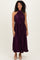 woman wearing a sleeveless dark purple pleated maxi dress with a halter neck and drawstring waist