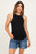 woman wearing a black ribbed maternity tank top and denim shorts, showing her baby bump