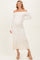 woman wearing a cream off-the-shoulder ribbed maternity dress with a side slit and a visible baby bump