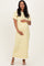 woman wearing a yellow and white striped maternity maxi dress and holding her baby bump