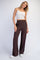 woman wearing a white cropped tank top and brown wide leg pants with an elastic waistband