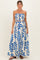 woman wearing a maternity two-piece set with a strapless crop top and a long skirt featuring a blue leaf print