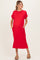 woman wearing a red short sleeve maternity dress with pockets and side slits, showing her baby bump