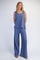 woman wearing a blue sleeveless top and matching wide-leg pants