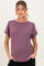 woman wearing a purple short sleeve maternity top with rolled sleeves and a visible baby bump