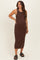 woman wearing a brown sleeveless maternity dress with a fitted silhouette and side slit, showcasing her baby bump
