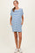 woman wearing a striped maternity dress with short sleeves and pockets, showing her baby bump