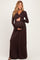woman wearing a chocolate brown long sleeve maternity dress and holding her baby bump