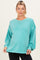 woman wearing a teal oversized sweatshirt with long sleeves and a relaxed fit, showing her baby bump