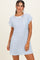 woman wearing a light blue and white striped short sleeve dress with a front pocket